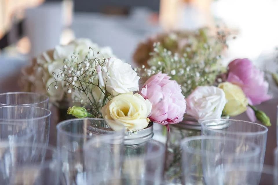 Moose Hollow Lodge venue showcasing floral centerpieces and elegant glassware on tables, creating a sophisticated event se...