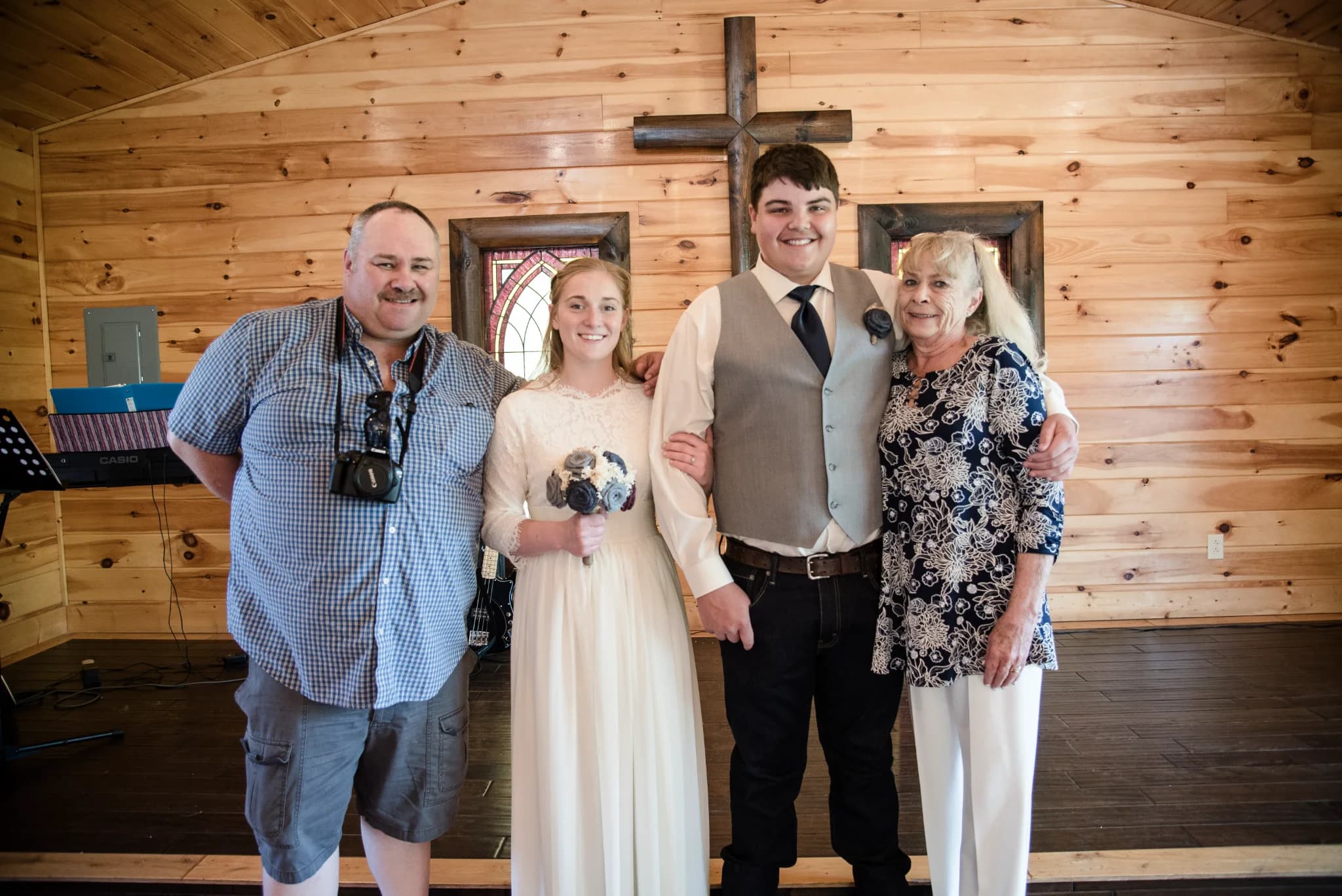 Rustic wood-paneled wedding chapel with stained glass and cross at Moose Hollow Lodge in Pigeon Forge