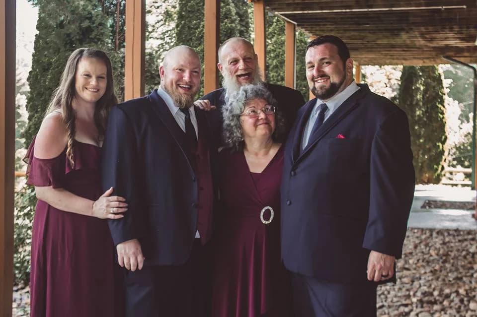 Smiling wedding guests on covered porch near Smoky Mountains at Moose Hollow Lodge in Pigeon Forge