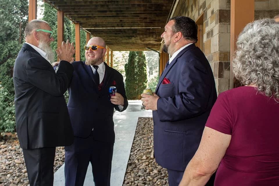 Groomsmen celebrating on a covered patio at Moose Hollow Lodge in Pigeon Forge near Dollywood and Smoky Mountains.
