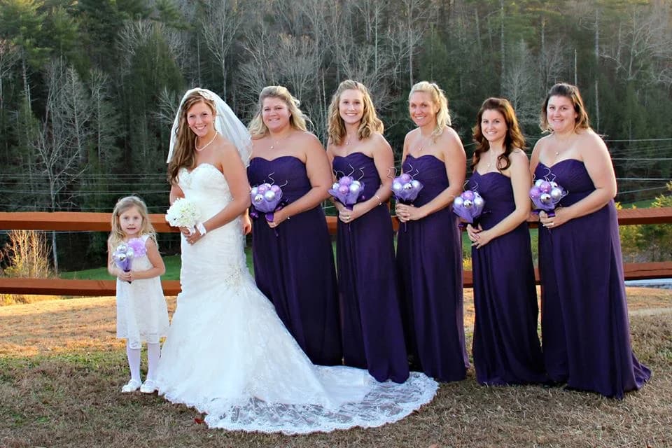 Bride and bridesmaids in purple gowns with forest views at Moose Hollow Lodge in Pigeon Forge near Smoky Mountains