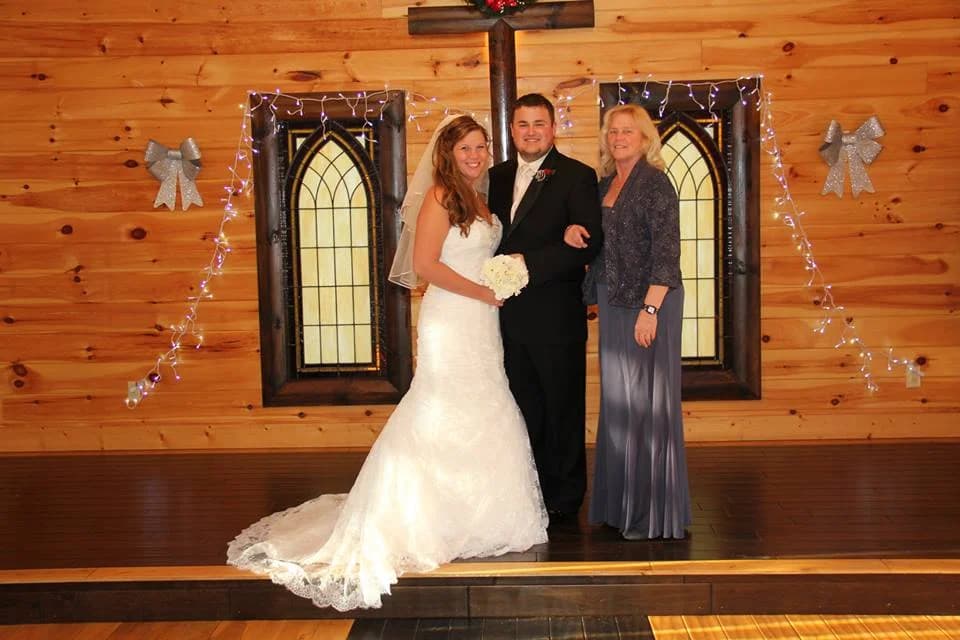 Rustic indoor chapel with wooden cross and stained glass windows at Moose Hollow Lodge in Pigeon Forge