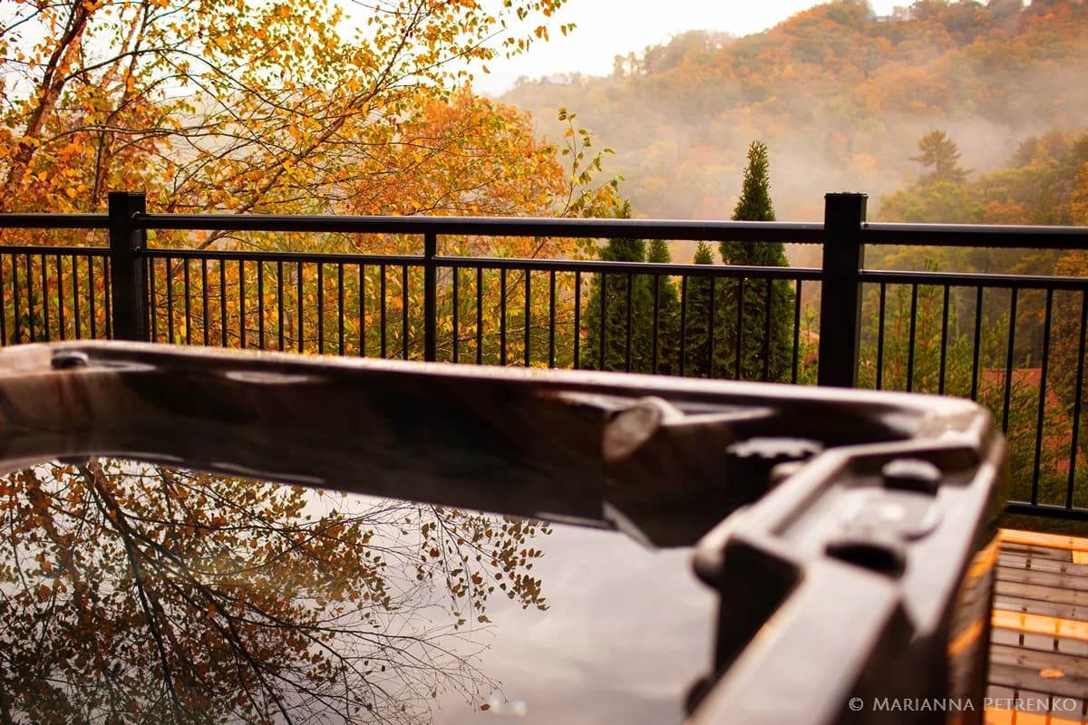 Hot tub on deck with misty fall Smoky Mountains views near Dollywood at Moose Hollow Lodge in Pigeon Forge