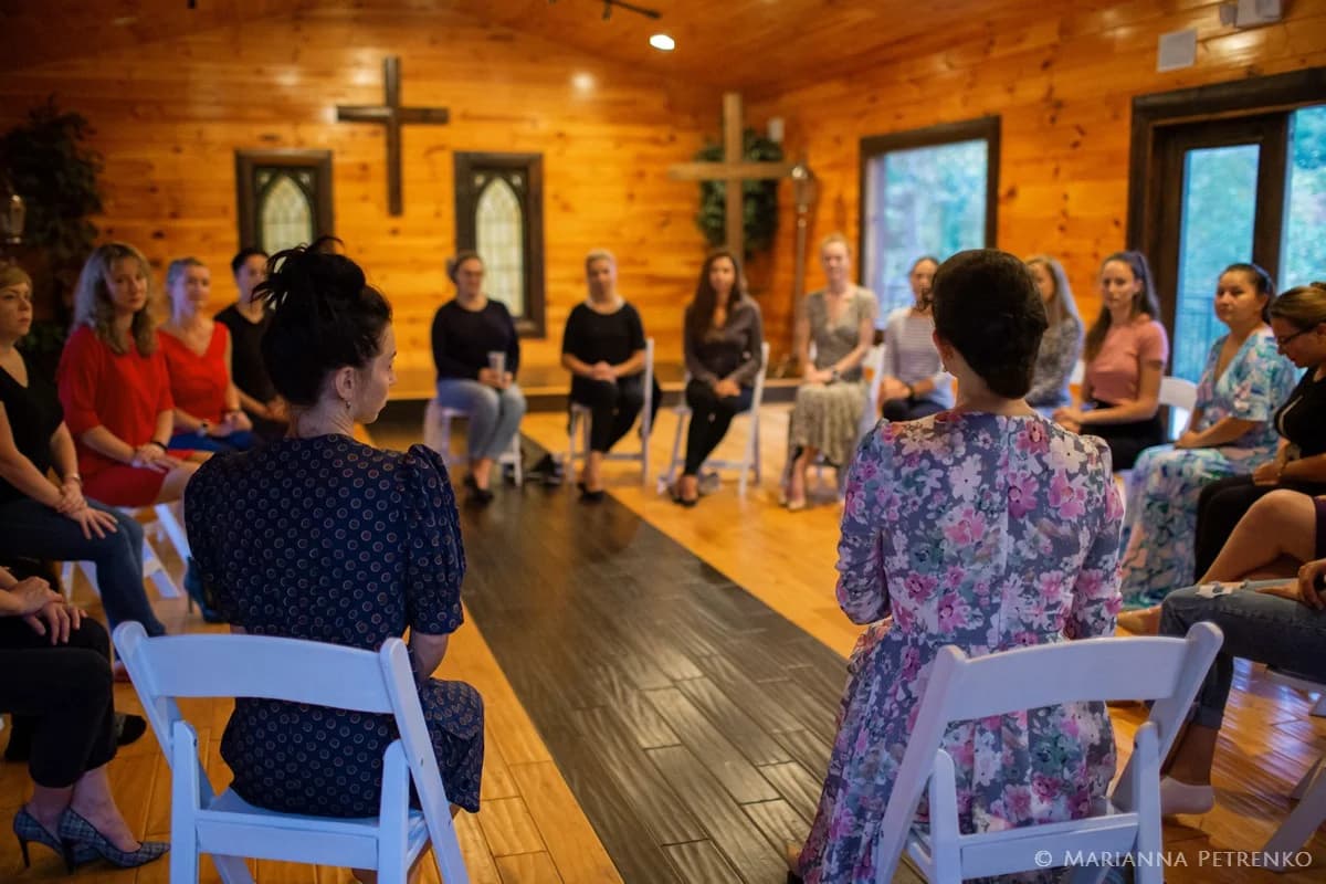 Rustic wood-paneled wedding chapel with white chairs at Moose Hollow Lodge in Pigeon Forge