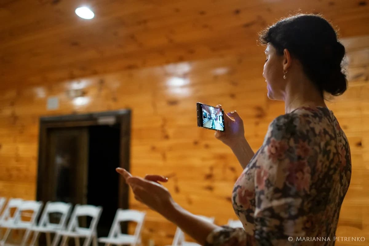 Rustic wedding venue with knotty pine walls and white event chairs at Moose Hollow Lodge in Pigeon Forge
