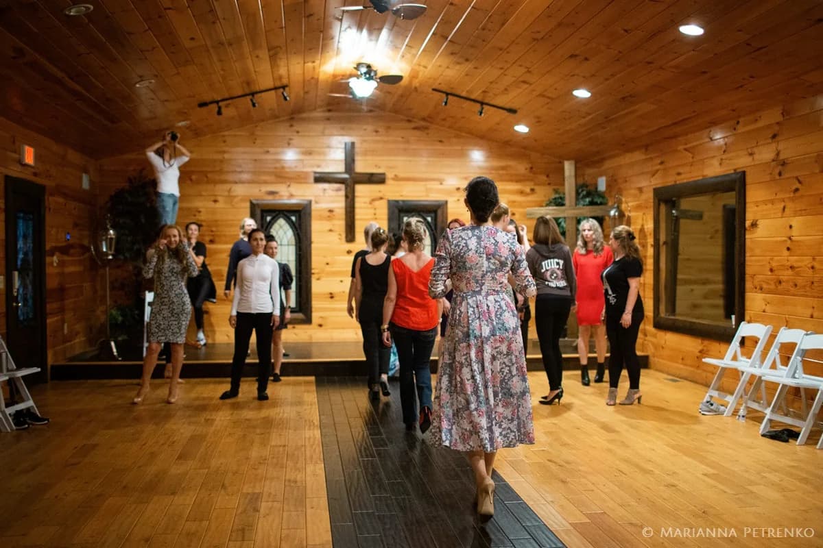 Rustic wood-paneled chapel interior with stage and crosses at Moose Hollow Lodge in Pigeon Forge