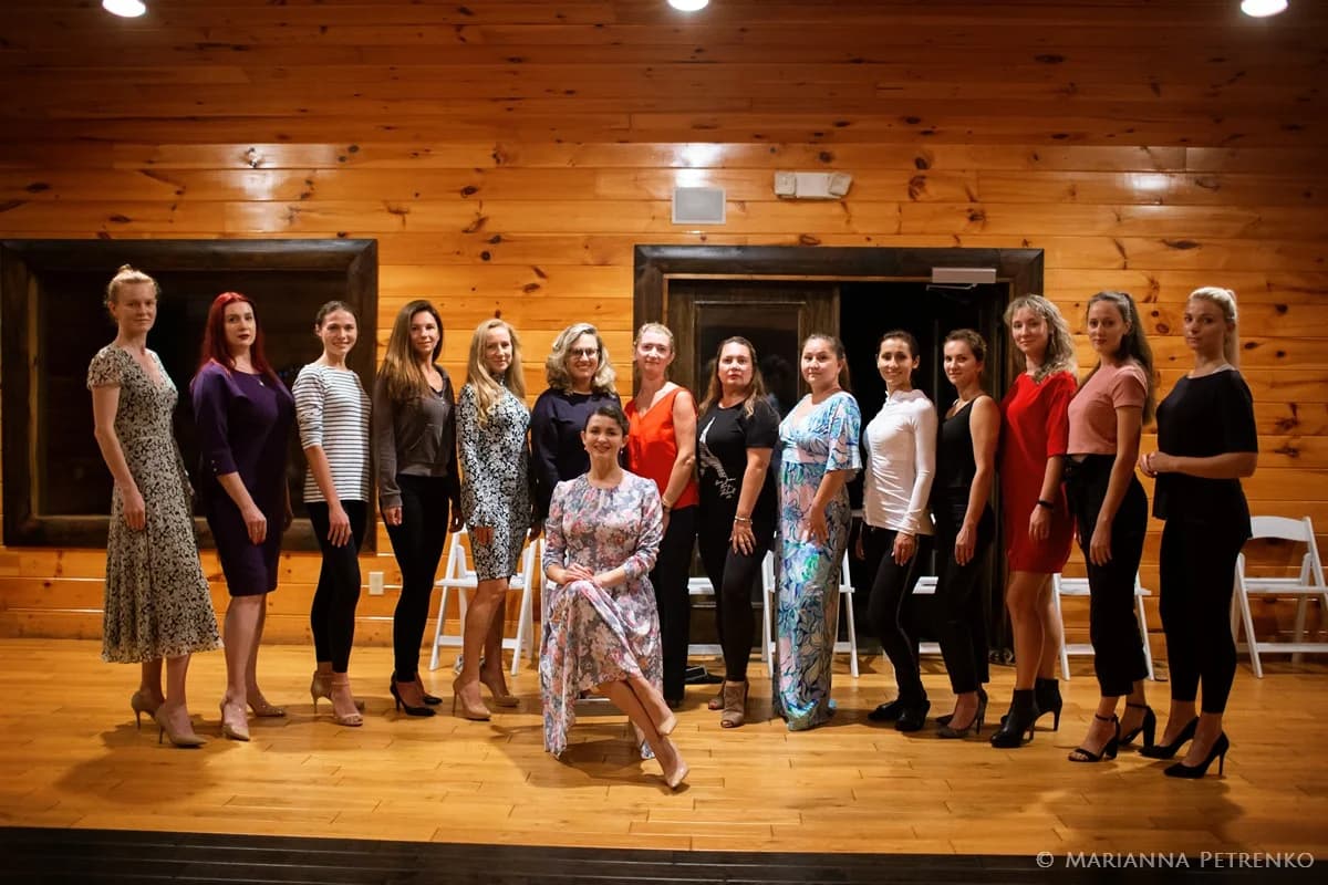 Group posing in a rustic wood-paneled indoor event room at Moose Hollow Lodge in Pigeon Forge