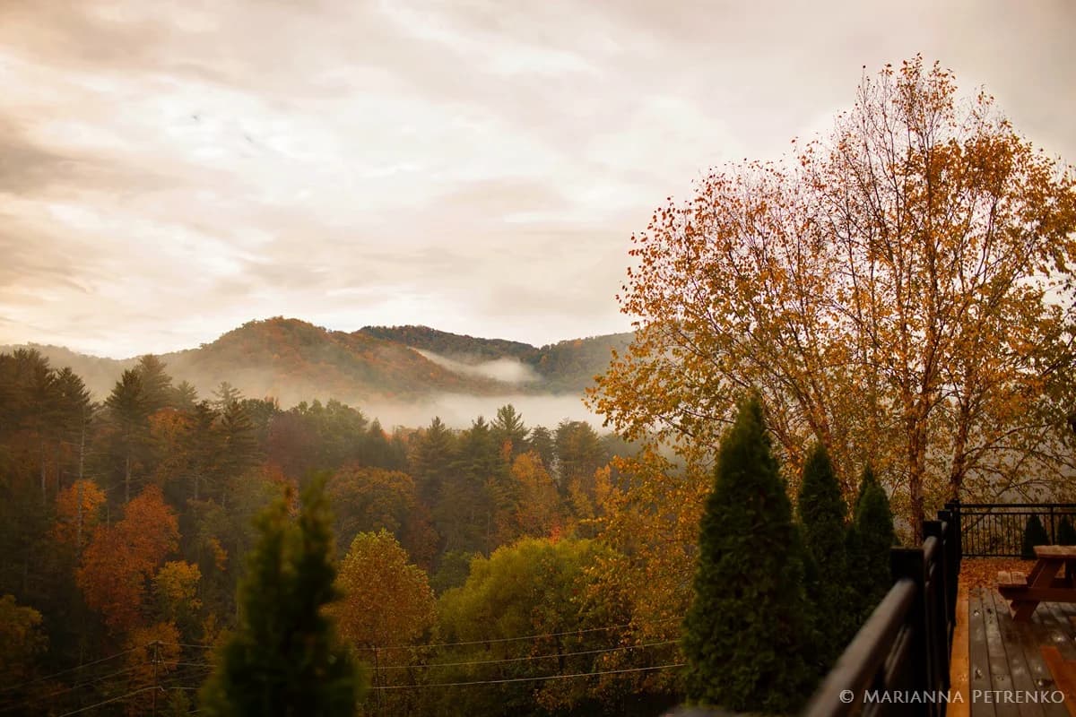 Misty autumn mountain views from deck with picnic table near Smoky Mountains at Moose Hollow Lodge in Pigeon Forge