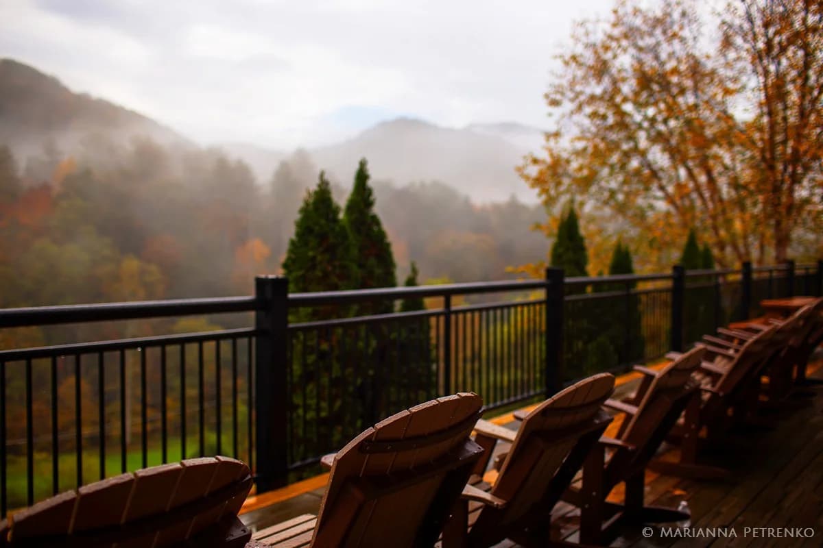 Adirondack chairs on deck with misty Smoky Mountains views near Dollywood at Moose Hollow Lodge in Pigeon Forge.
