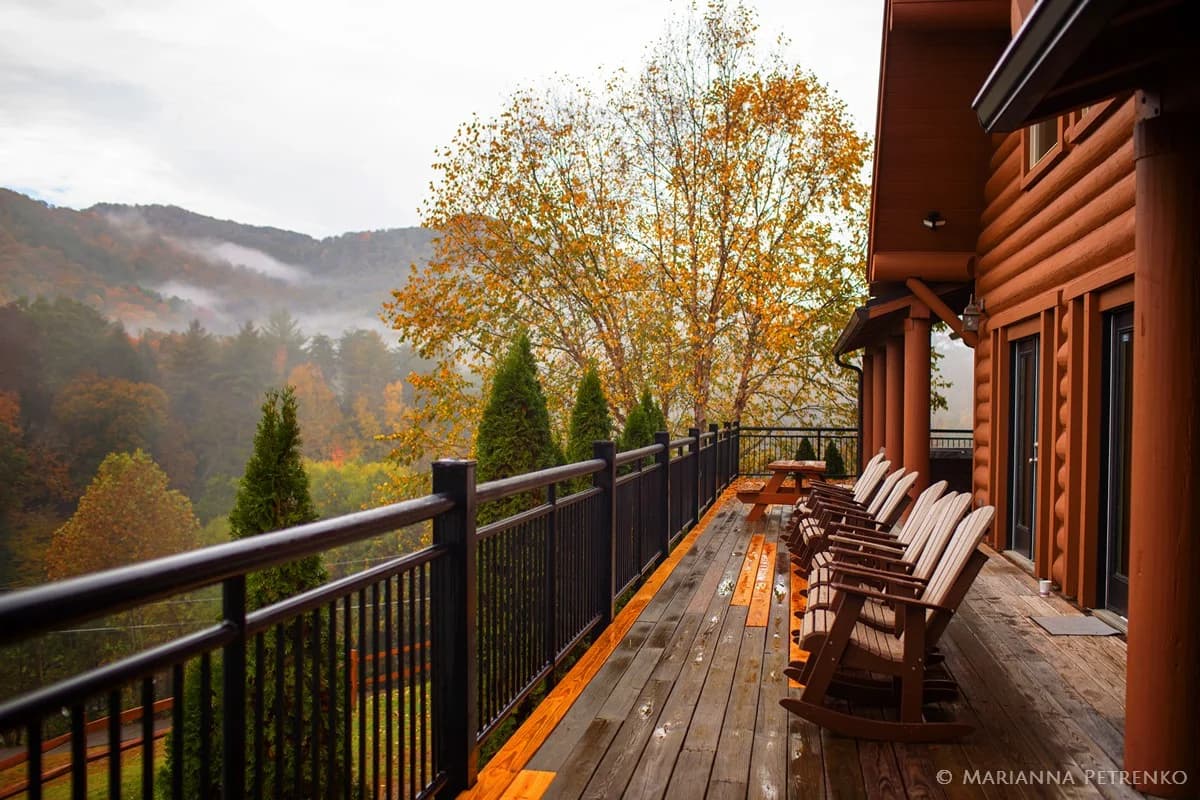 Rocking chairs on a deck with misty Smoky Mountains views near Dollywood at Moose Hollow Lodge in Pigeon Forge
