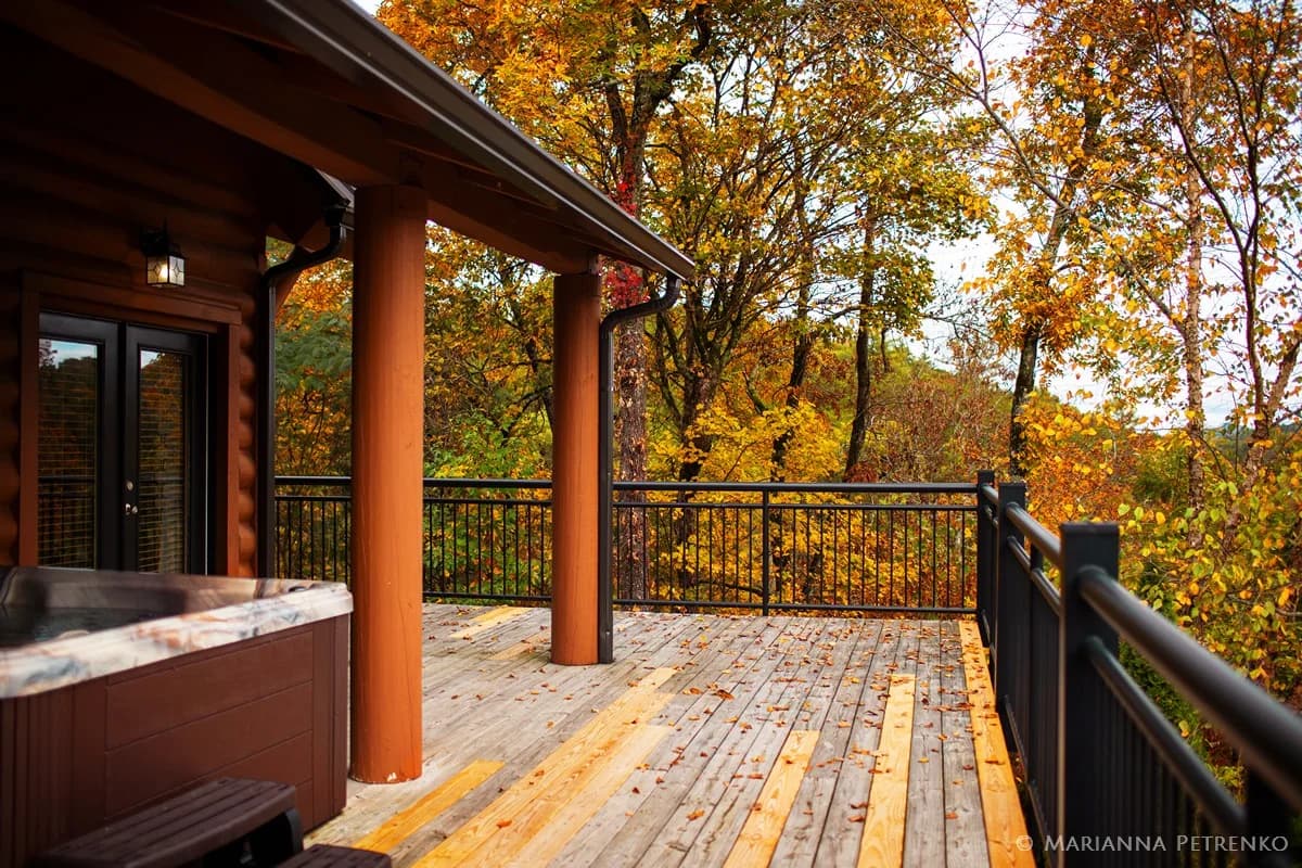 Private hot tub on a deck with autumn forest views near the Smoky Mountains at Moose Hollow Lodge in Pigeon Forge