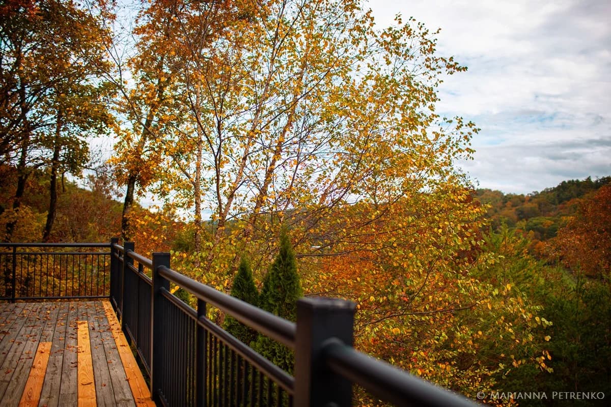 Wooden deck with railing and autumn mountain views at Moose Hollow Lodge near Dollywood and Smoky Mountains