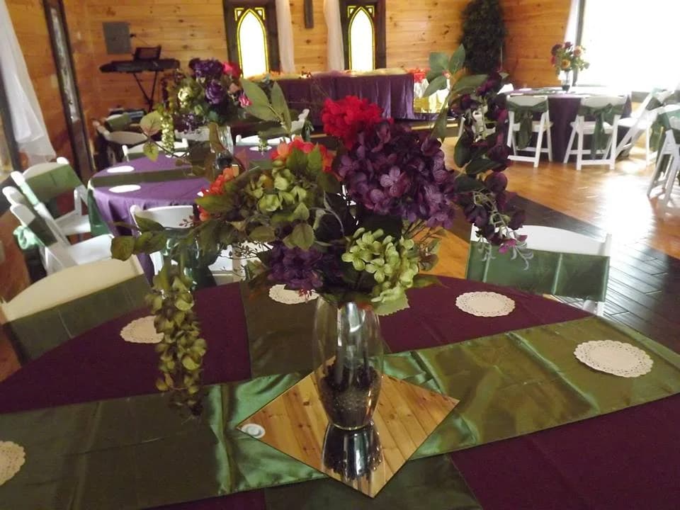 Elegant wedding reception hall with floral centerpieces and purple decor at Moose Hollow Lodge in Pigeon Forge