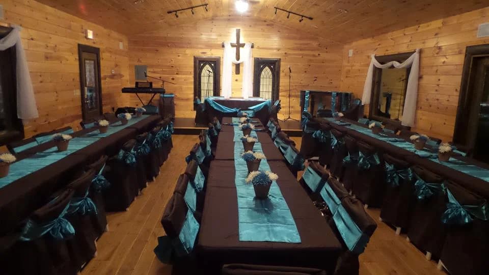 Rustic wood-paneled chapel and event hall with banquet seating at Moose Hollow Lodge in Pigeon Forge
