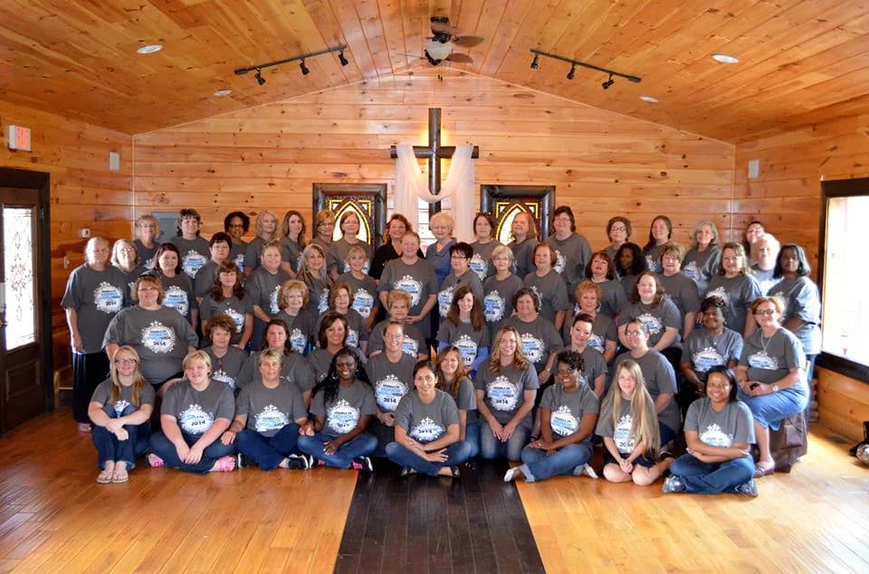 Large group in the rustic wood-paneled chapel and meeting room at Moose Hollow Lodge in Pigeon Forge