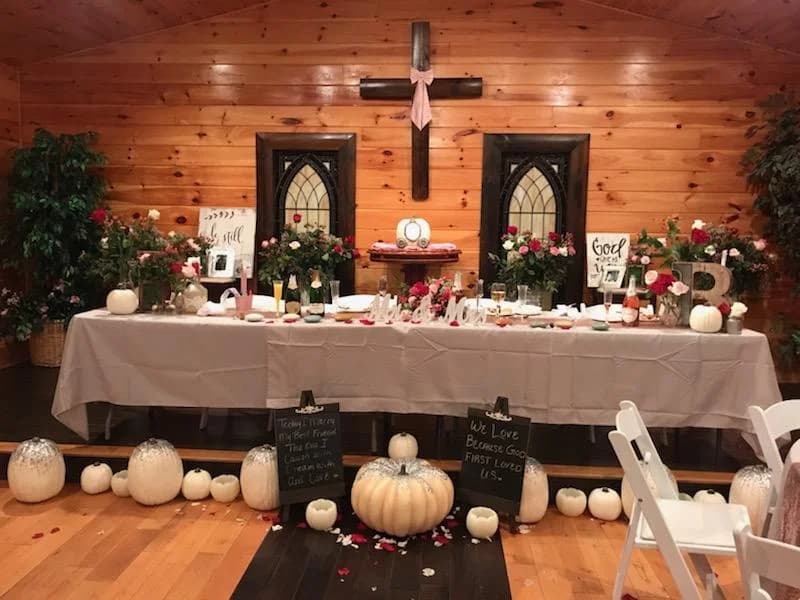 Rustic wedding chapel reception table with pumpkins and floral decor at Moose Hollow Lodge in Pigeon Forge