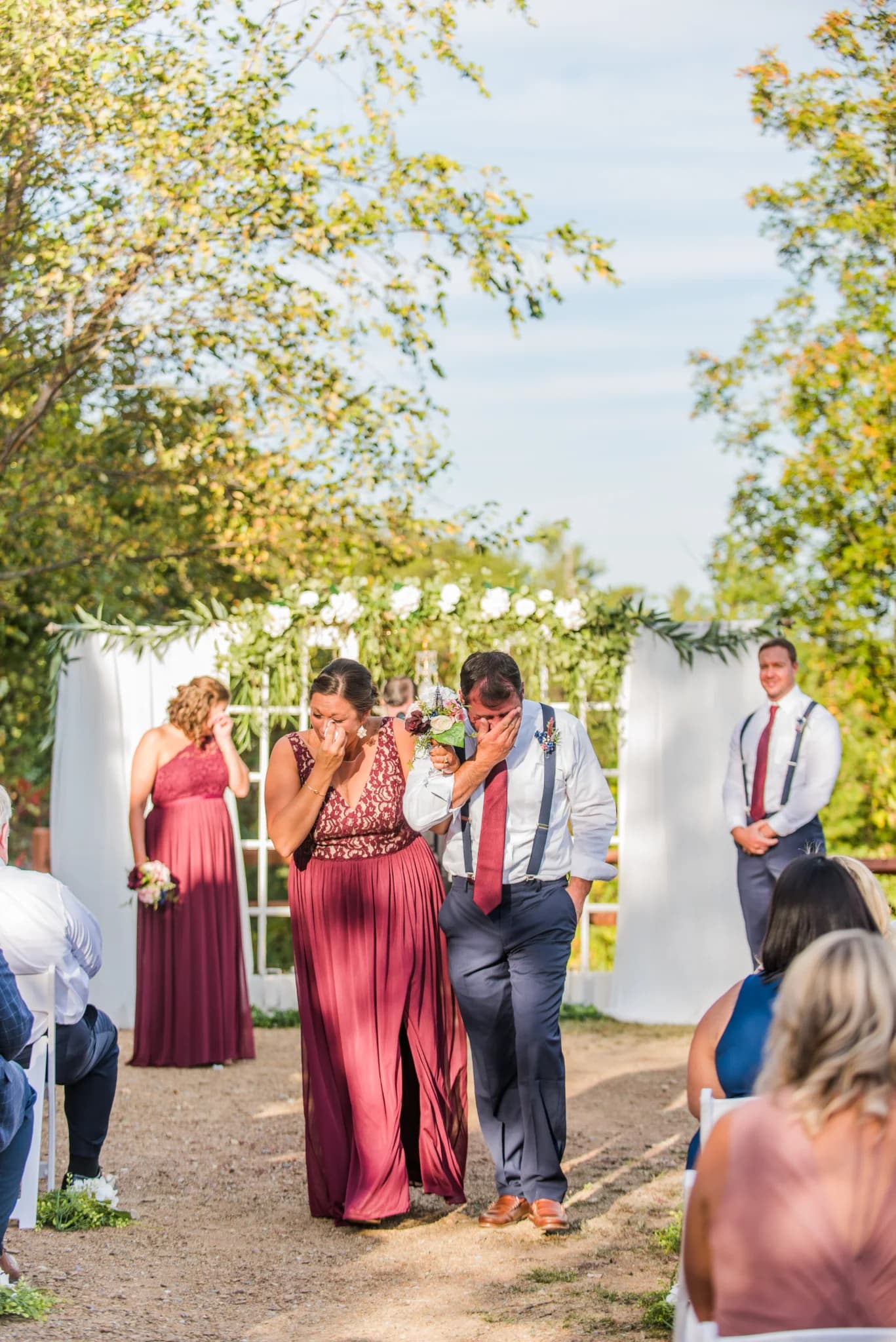 Emotional outdoor wedding ceremony with floral arch near Smoky Mountains at Moose Hollow Lodge in Pigeon Forge