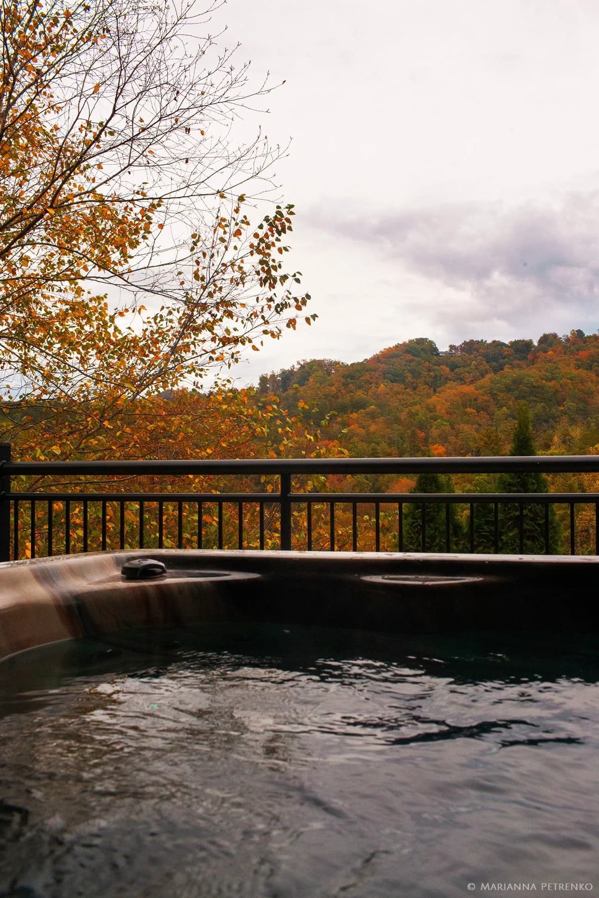 Steaming hot tub with autumn Smoky Mountains views near Dollywood at Moose Hollow Lodge in Pigeon Forge