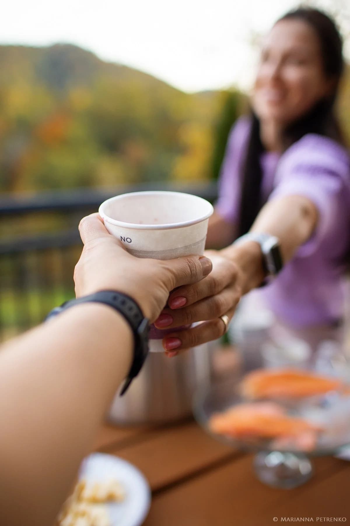 Sharing drinks on a deck with Smoky Mountain views near Dollywood at Moose Hollow Lodge in Pigeon Forge