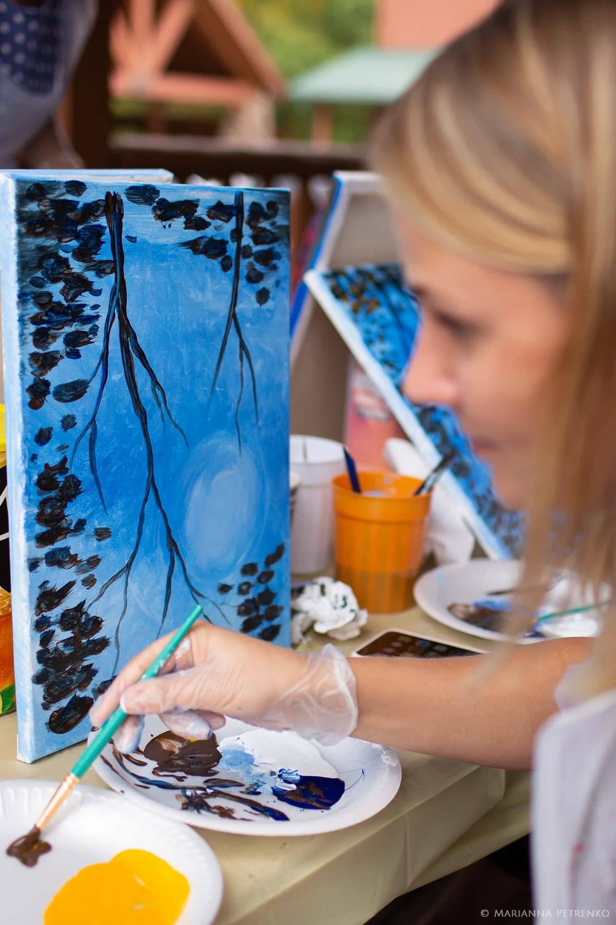 Outdoor painting activity on the deck near the Smoky Mountains at Moose Hollow Lodge in Pigeon Forge