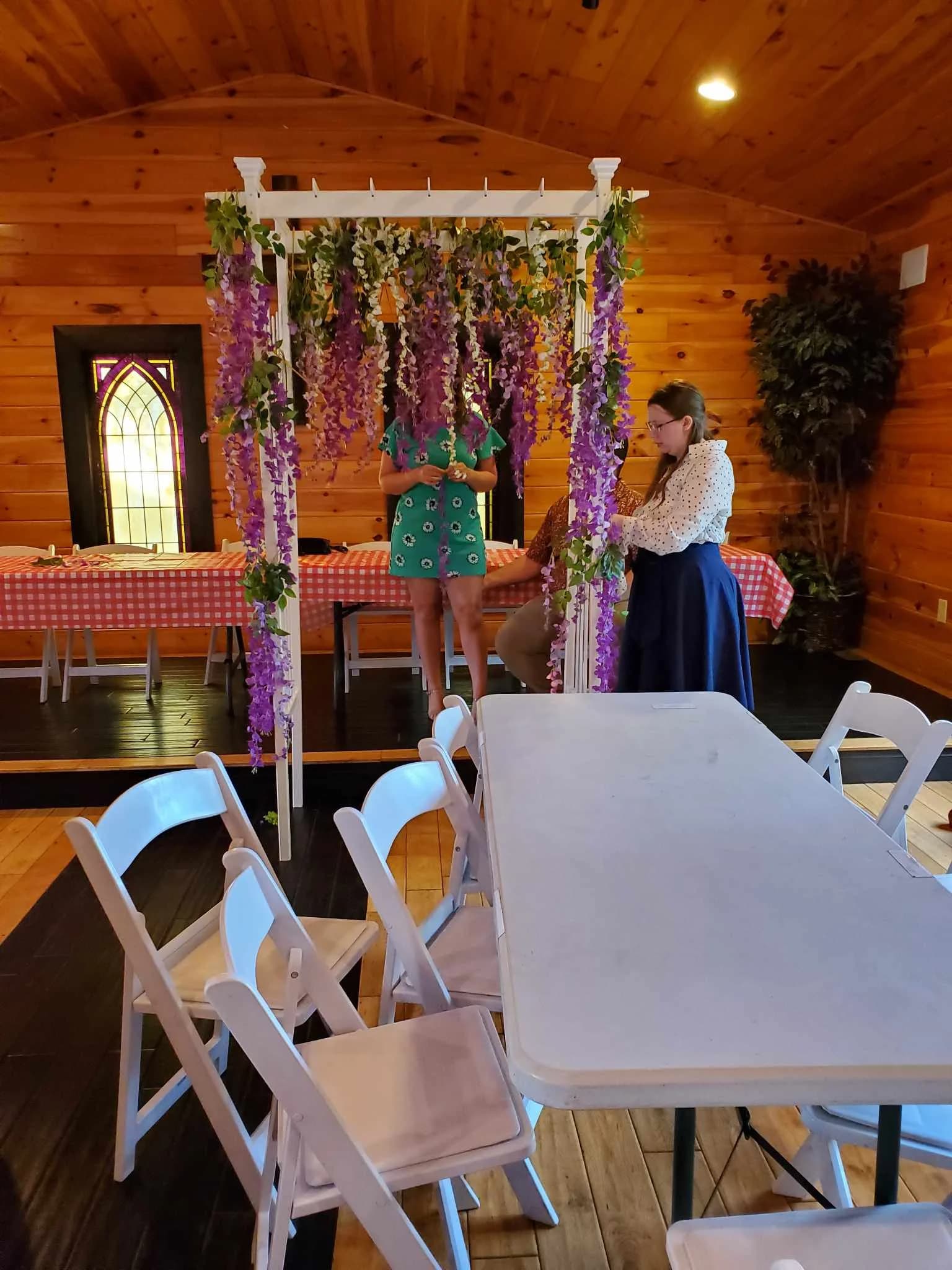 Rustic event hall with floral wedding arbor and guest seating at Moose Hollow Lodge in Pigeon Forge
