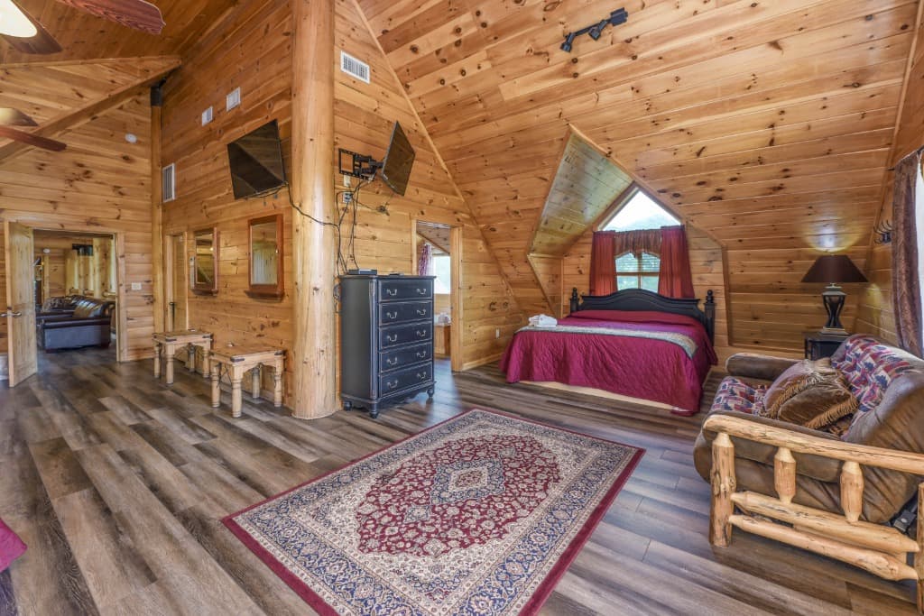 Spacious log cabin bedroom with king bed and vaulted ceilings at Moose Hollow Lodge in Sevierville