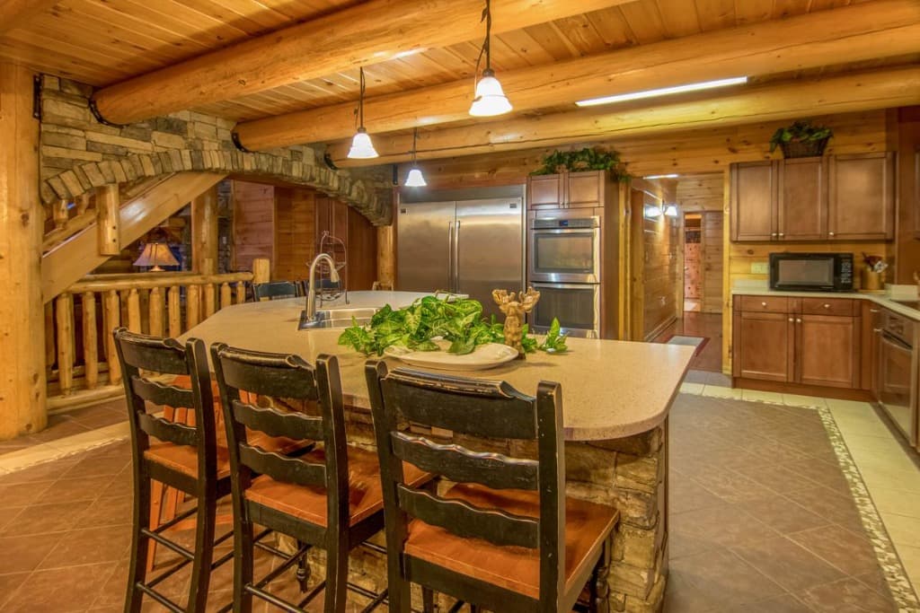 Spacious cabin kitchen with large stone island and stainless appliances at Moose Hollow Lodge in Sevierville