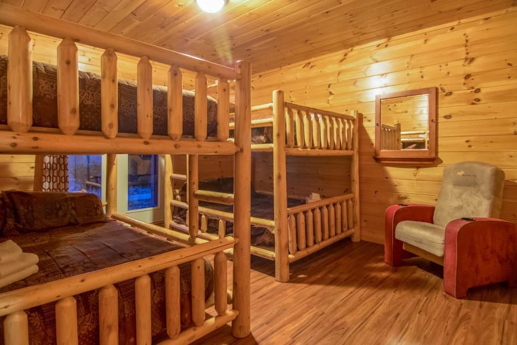 Rustic log bunk beds and wooden interiors in Bedroom 8 at Moose Hollow Lodge in Sevierville.