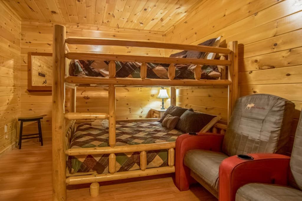 Rustic log bunk beds and theater seating in Bedroom 9 at Moose Hollow Lodge in Sevierville